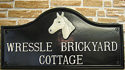 Here is a sample of  a long name set out in in two lines in Condensed Times lettering on a Lancaster sign.  The letters are painted white to match the white horses head
