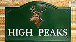This Lancaster sign shows a beautifully painted emblem of a stags head on a green background with white Times lettering