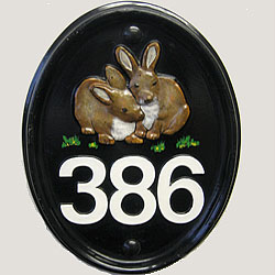 Our Mews plaque can be used vertically as well as horizontally to accommodate a number and a slightly larger emblem, in this case two little rabbits