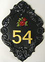 This black ornate Bath Plus number plaque, with its gold numerals and red cluster of roses, gives a feeling of richness and splendour