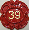 A Victorian number plaque in red with gold number