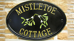 The realistic appearance of the mistletoe on this Oxford 1510 sign looks as though it has just been gathered. The gold lettering is set out in Times Condensed