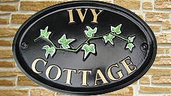 Here is a sample of an Oxford sign with an ivy emblem, set out in gold Times lettering